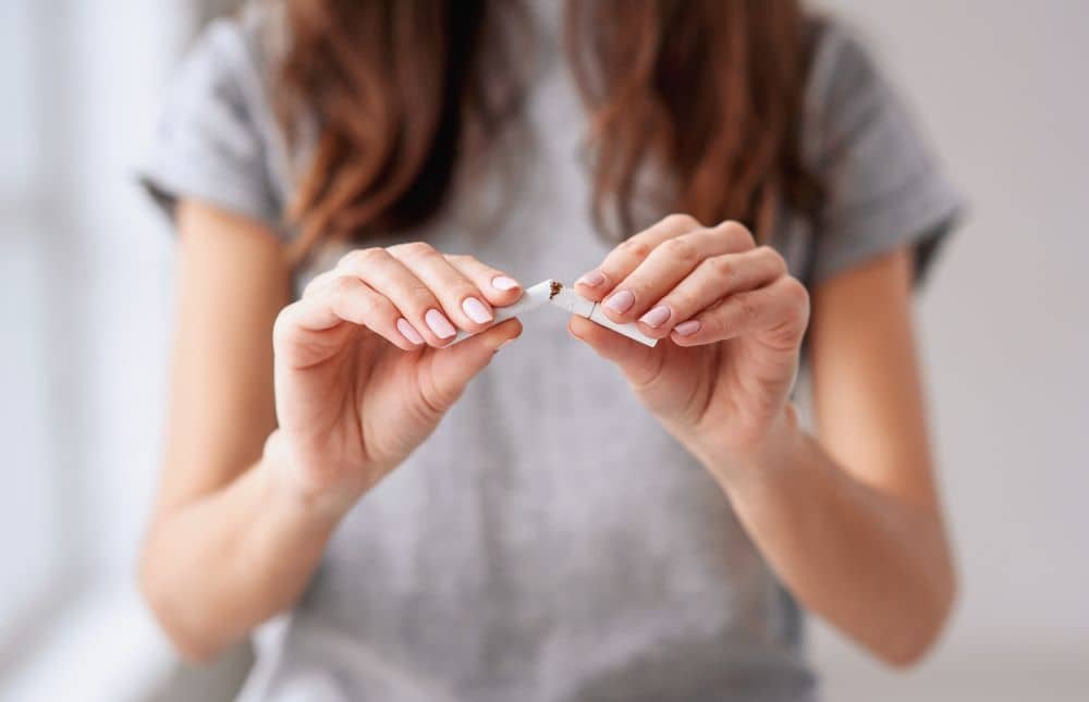 Woman Breaking Cigarette